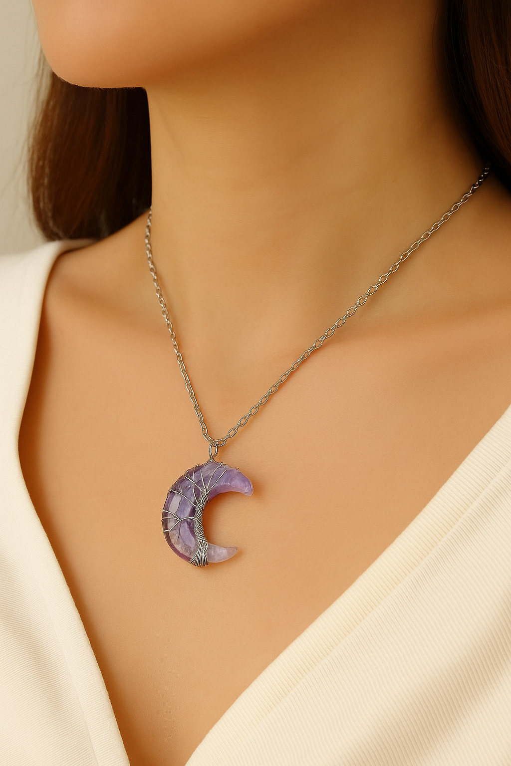 Purple crescent moon necklace on a model wearing a beige top