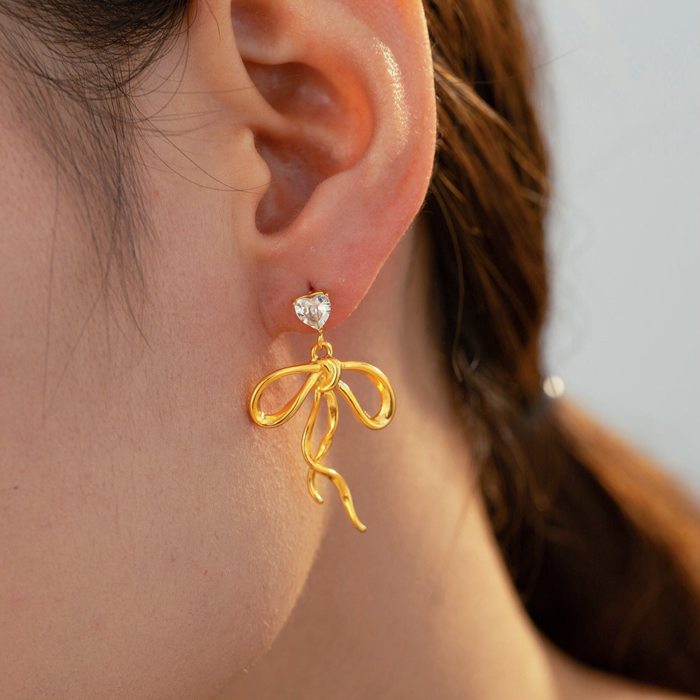Model wearing Celeste Bow Earrings – gold-plated stainless steel bow design