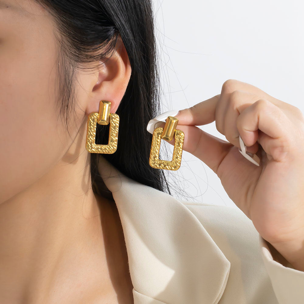 Model wearing Gilded Links Earrings – anti-tarnish textured gold drop earrings