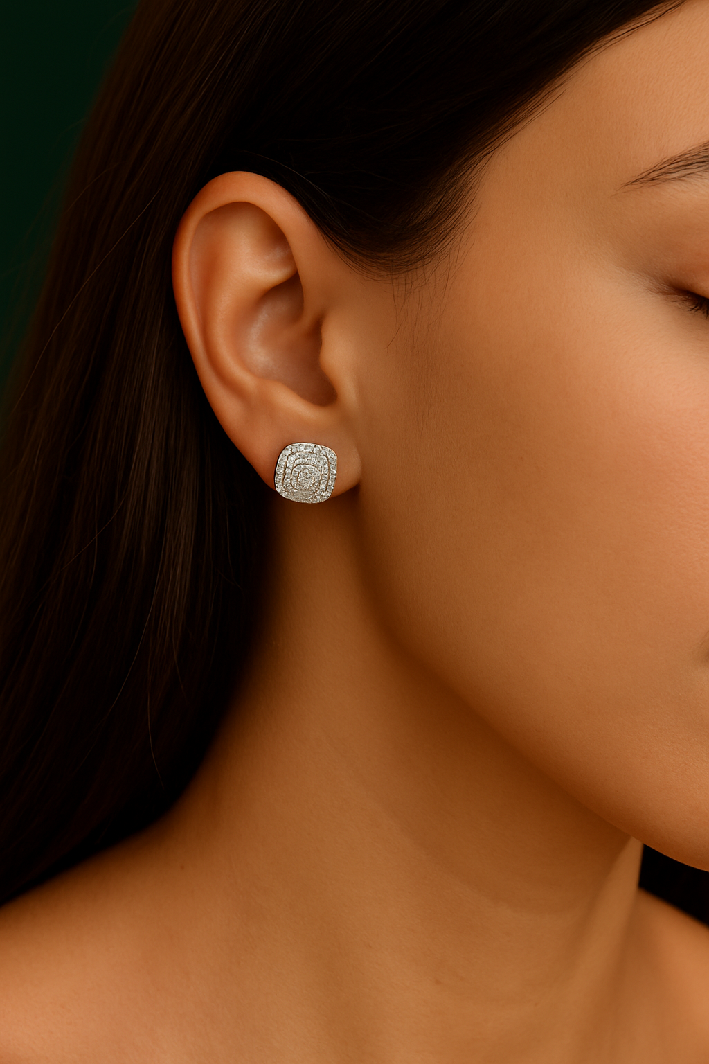 Close-up of a person wearing a silver earring with a dark background