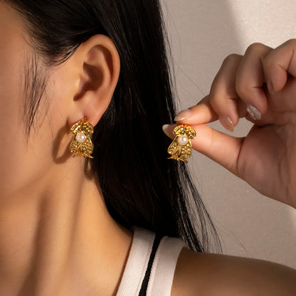 Model wearing Auric Twist Hoop Earrings – anti-tarnish leaf design with pear