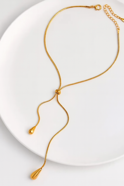 Gold necklace on a white plate