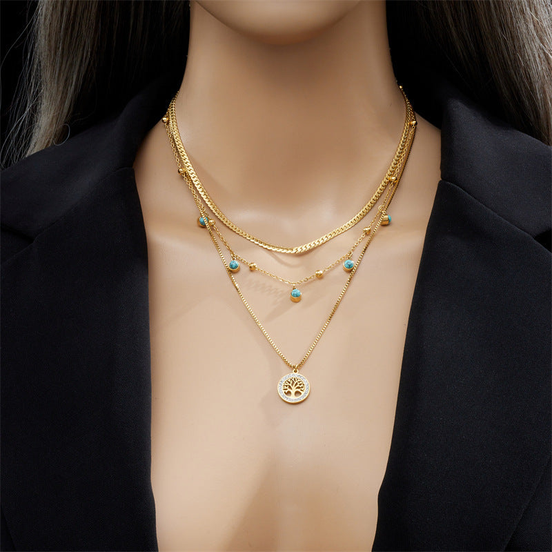 Model wearing Emerald Cascade Necklace with anti-tarnish finish, elegant jewelry