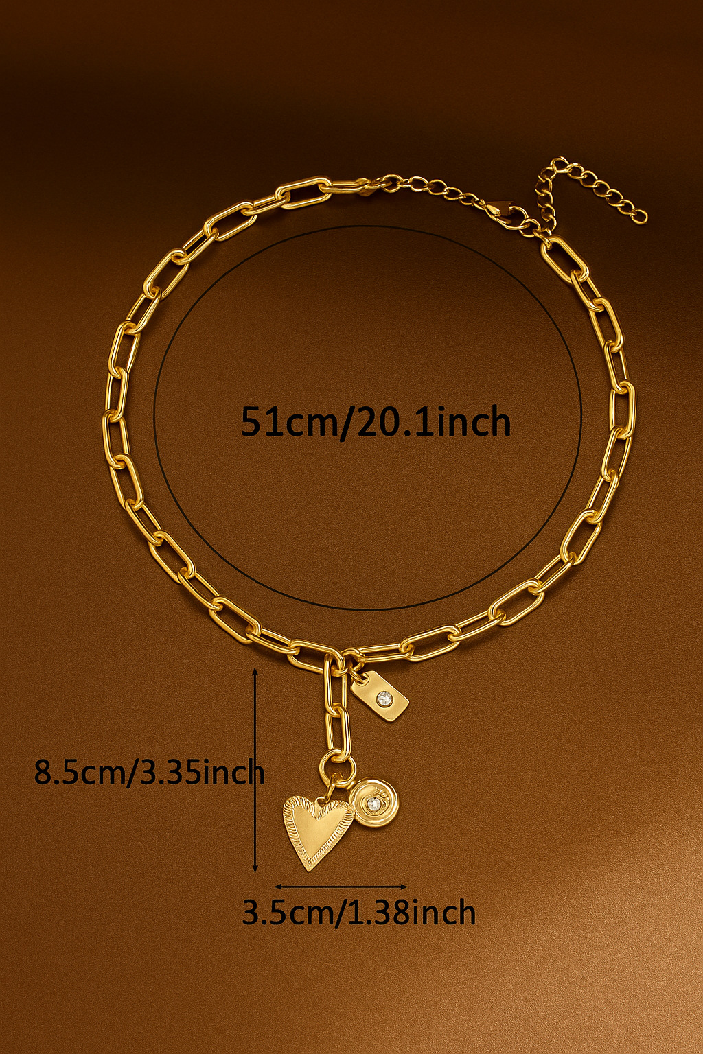 Gold chain bracelet with heart-shaped charm and measurements on a brown background